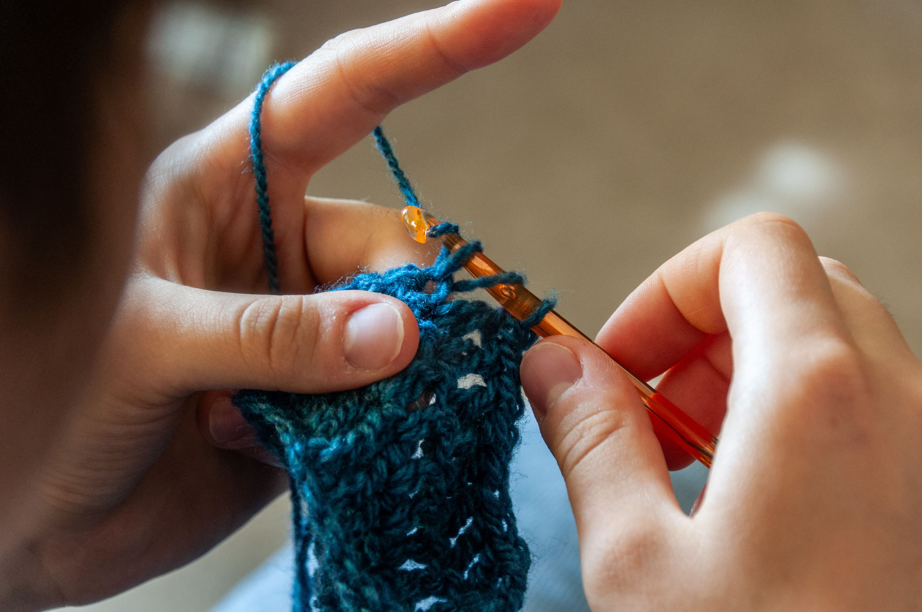 Artisan hands crocheting yarn